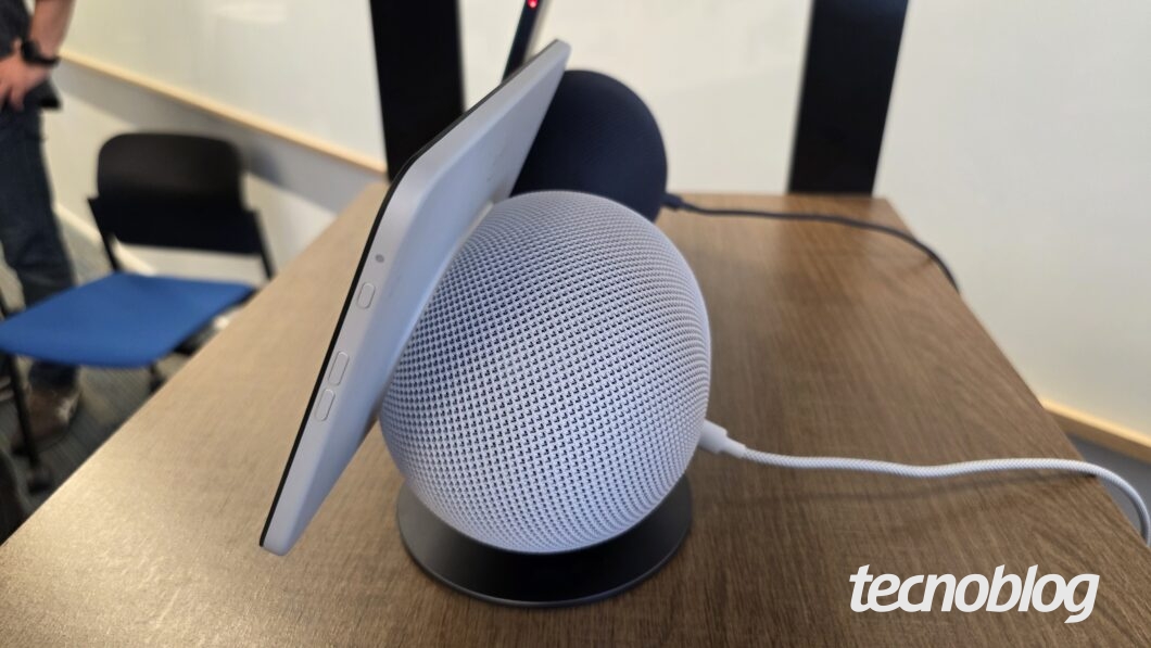 Alto-falante inteligente com tela sobre uma mesa, visto pela lateral