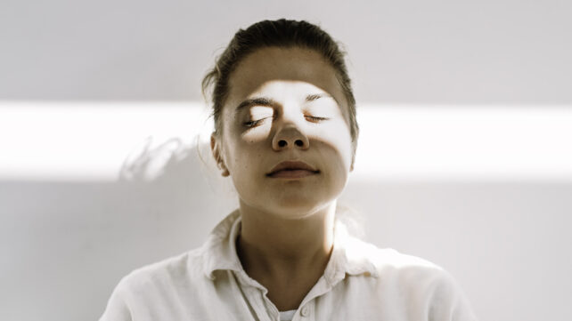 Woman daydreaming in the light