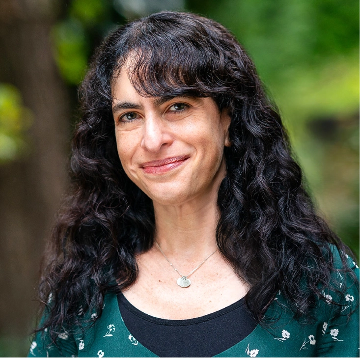 Portrait of a woman with curly black hair.