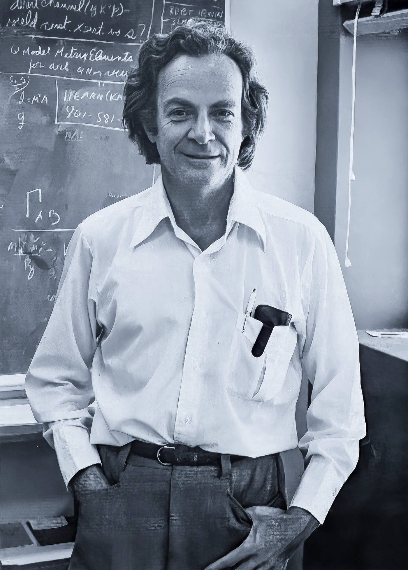 Photo of a man in a white shirt with his hands in his pockets. A blackboard covered with equations appears in the background.