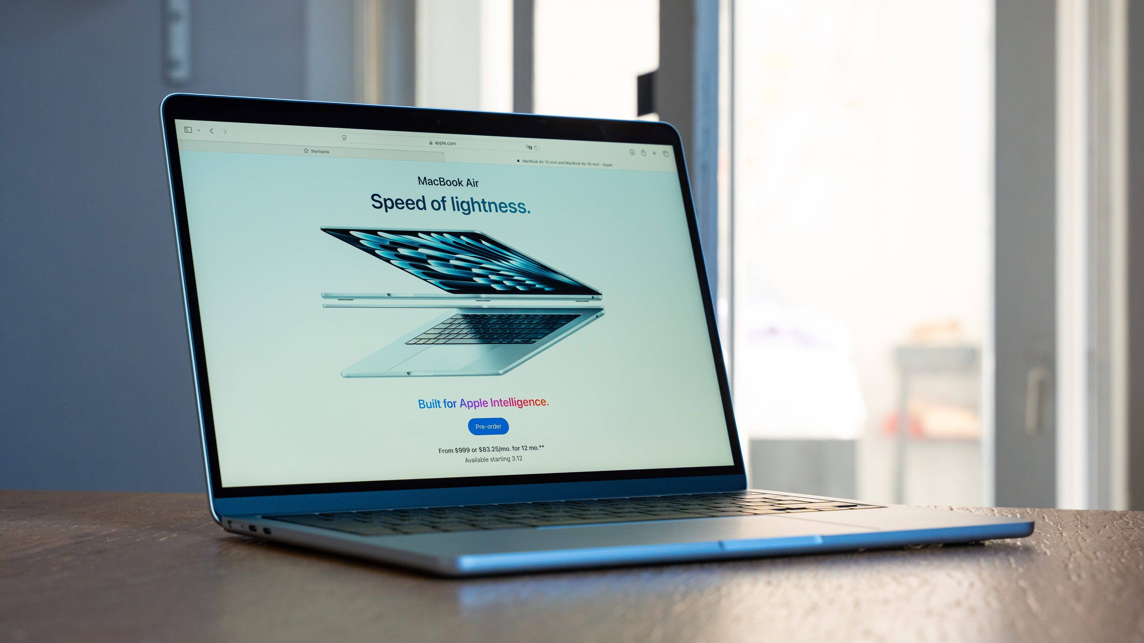 A MacBook Air displaying 'Speed of lightness' and 'Built for Apple Intelligence' on its screen.