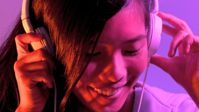 Young woman with dark hair wearing headphones