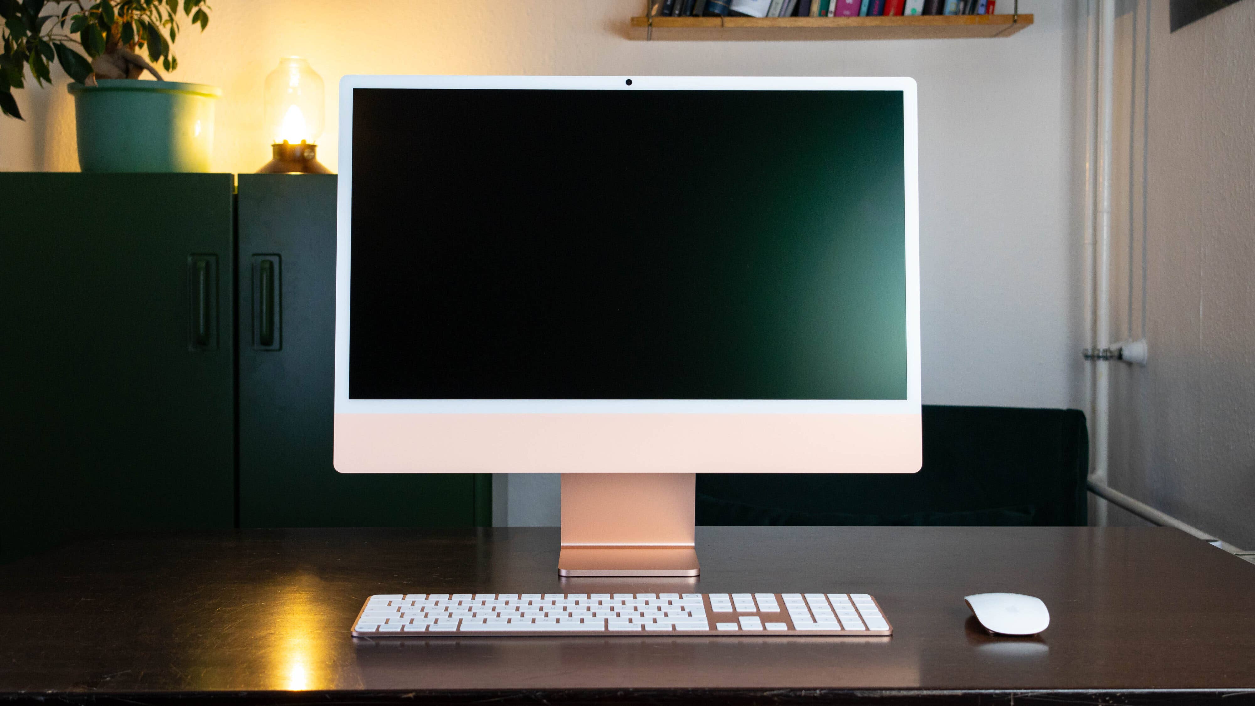 A sleek Apple iMac M4 2024 on a wooden desk, featuring a blank screen, keyboard, and mouse.