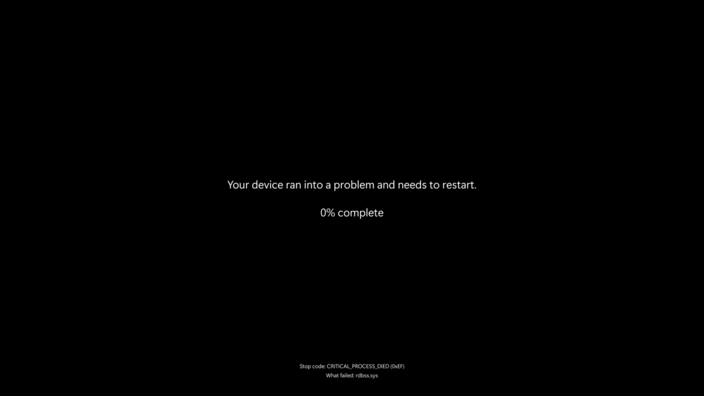 Tela preta com texto branco centralizado exibindo uma mensagem de erro do sistema operacional Windows. A mensagem diz: "Your device ran into a problem and needs to restart. 0% complete". Na parte inferior da tela, em menor tamanho, está escrito: "Stop code: CRITICAL_PROCESS_DIED (0xEF)" e "What failed: rdbss.sys". Não há outros elementos visuais presentes.