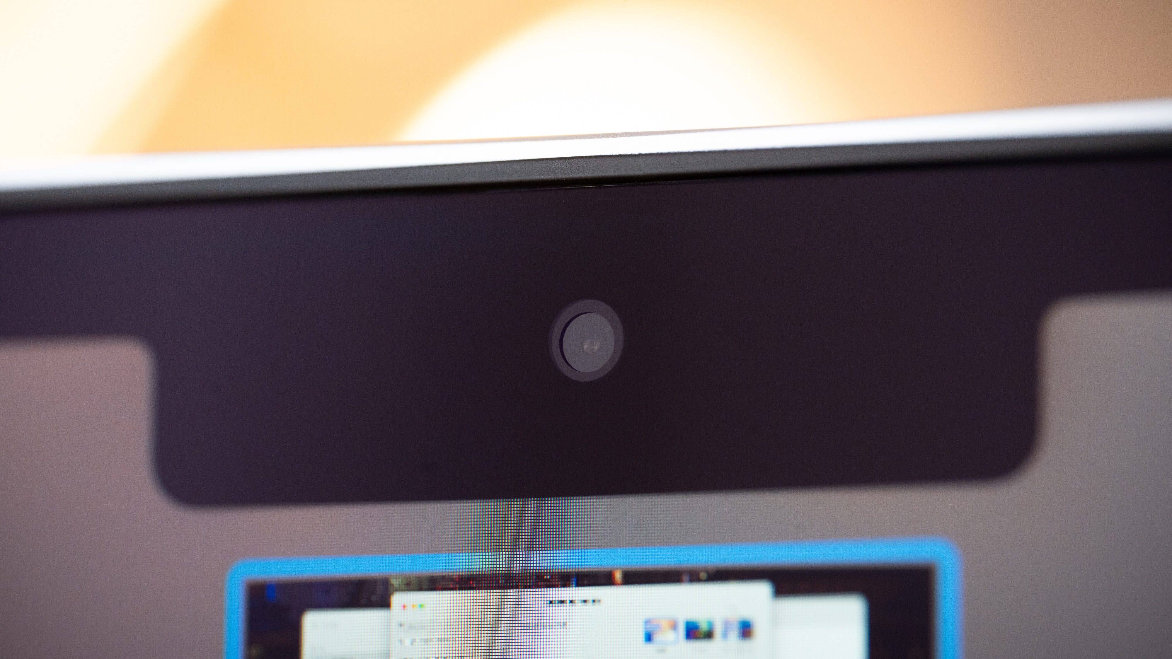 Close up of a MacBook Air M4 webcam with a blurry screen background.