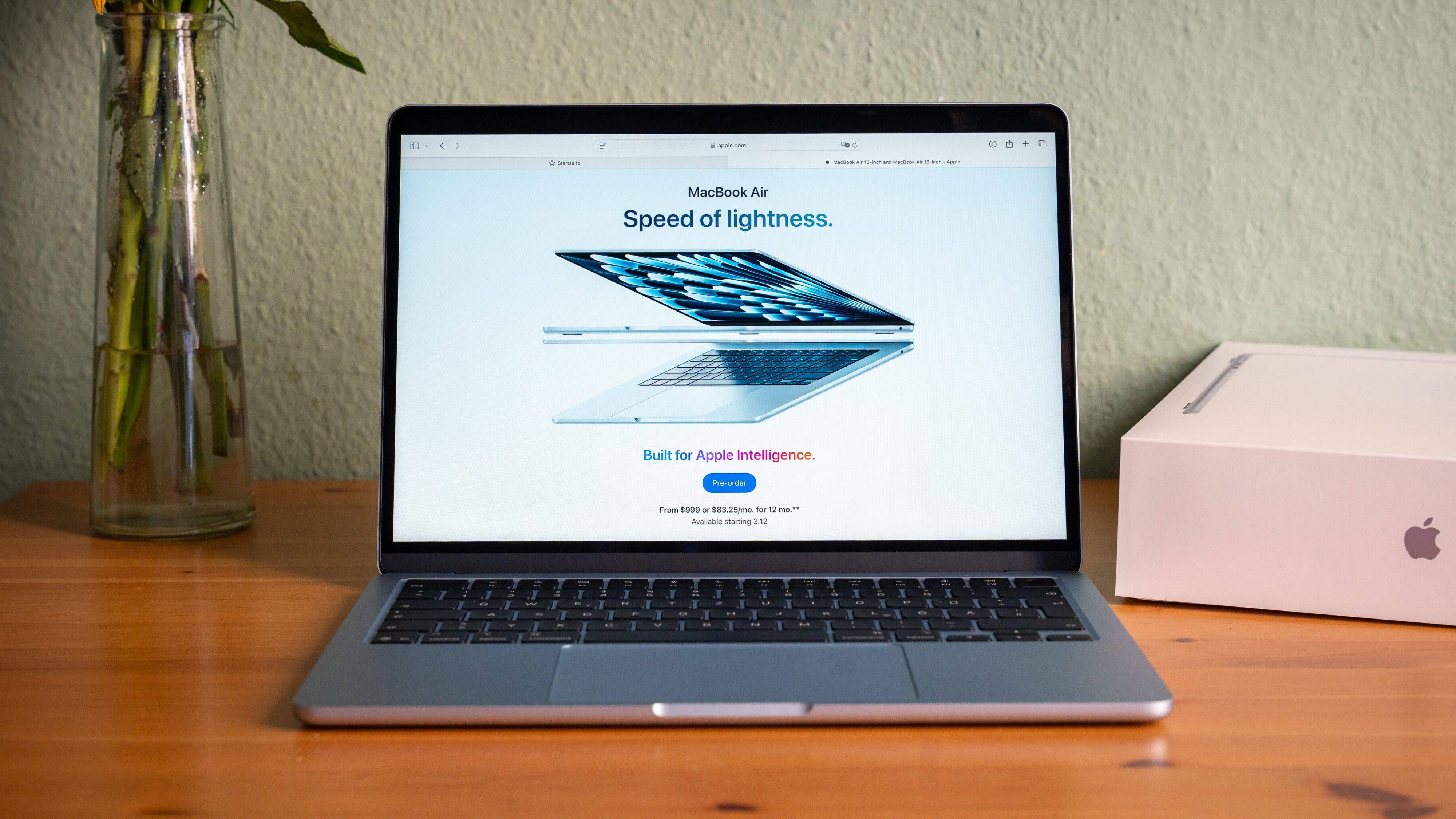 Apple MacBook Air with the u0027Speed of lightnessu0027 motto, sporting a sleek design on a wooden table.