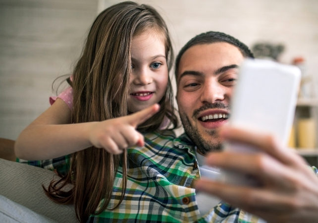 parent and child looking at their phone