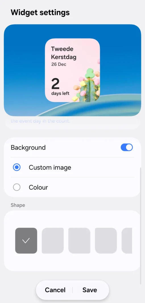 Captura de tela das configurações de um widget do aplicativo Calendário da Samsung. No topo, lê-se “Widget settings”. Há a prévia de um widget com um cartão arredondado exibindo “Tweede Kerstdag”, “26 Dec” e “2 days left”, sobre uma imagem decorativa com um cacto. Abaixo, a seção “Background” está ativada, com a opção “Custom image” selecionada e “Colour” desmarcada. Mais abaixo, há opções de formato (“Shape”) e botões “Cancel” e “Save” no rodapé.