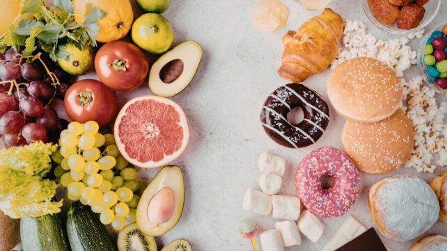 Image of a white space with healthy fresh fruit on the left and processed foods on the right