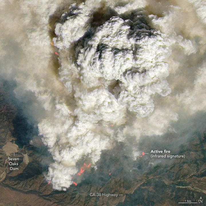 White clouds forming from smoke particles over blazing fires