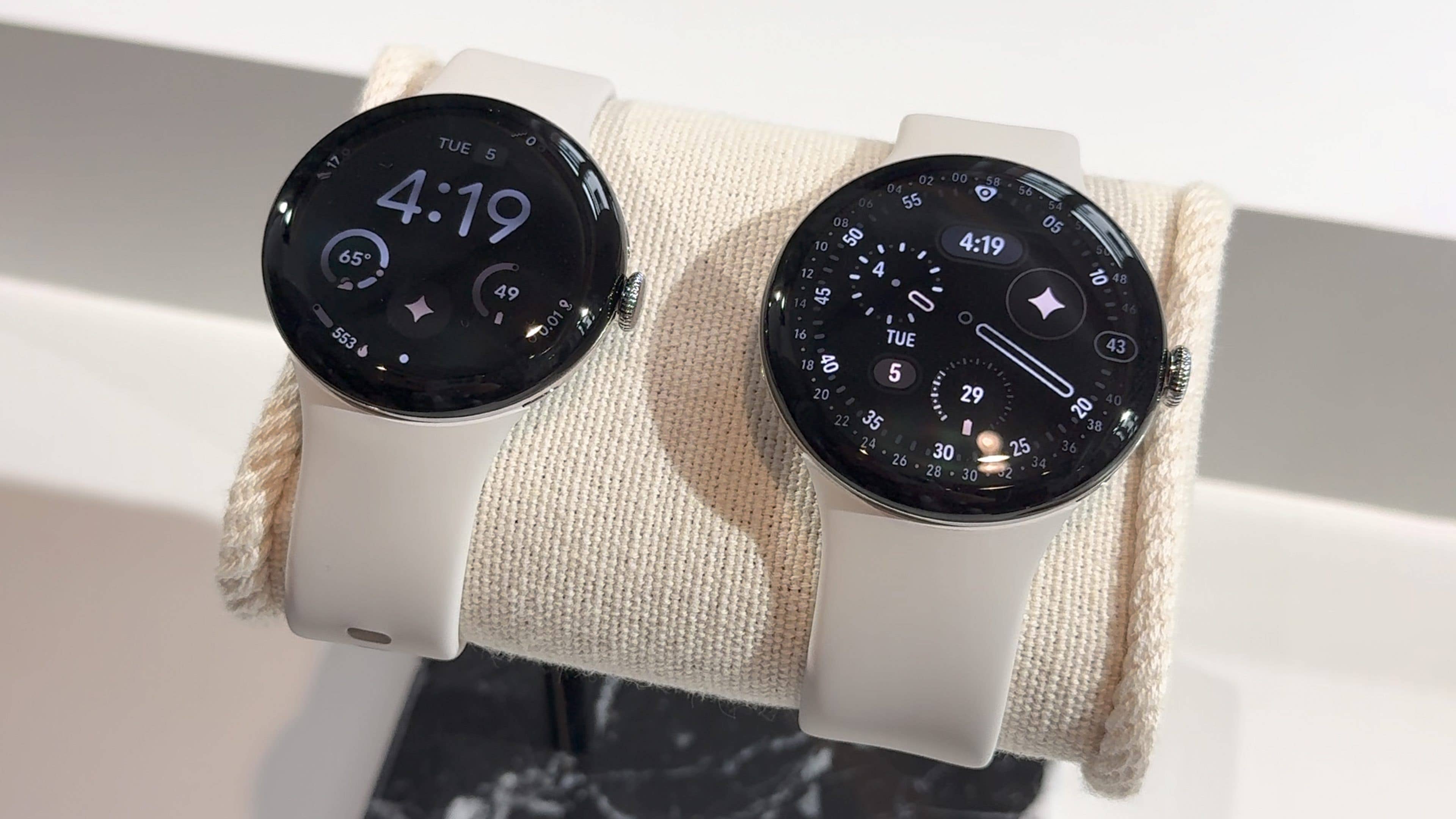 Two Google Pixel Watch 4s on a display, showing the time 4:19 and various fitness metrics.