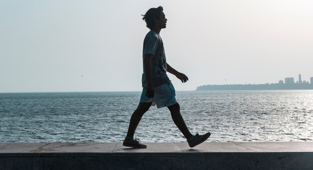 person walking by the water