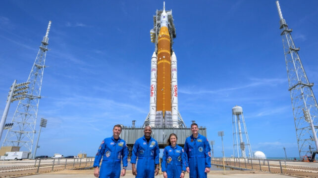 Four NASA astronauts in front of the Artemis 2 mission's rocket