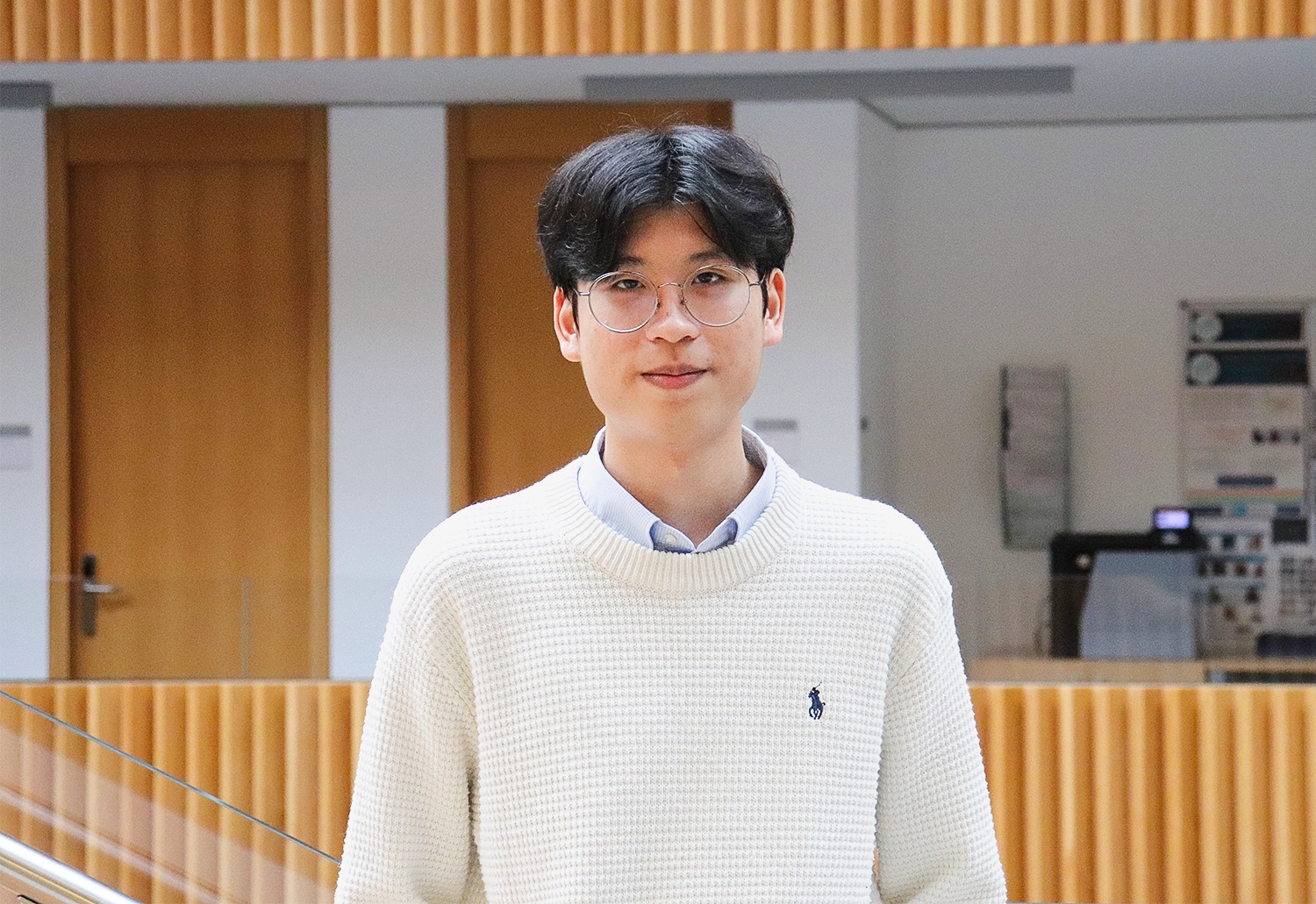 Man wearing glasses and a sweater.