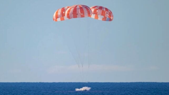 Orion with parachutes in ocean