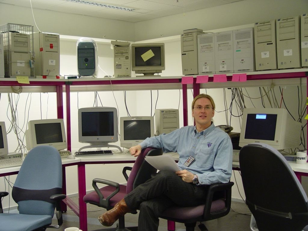 a younger Mikko Hyppönen surrounded by computers.