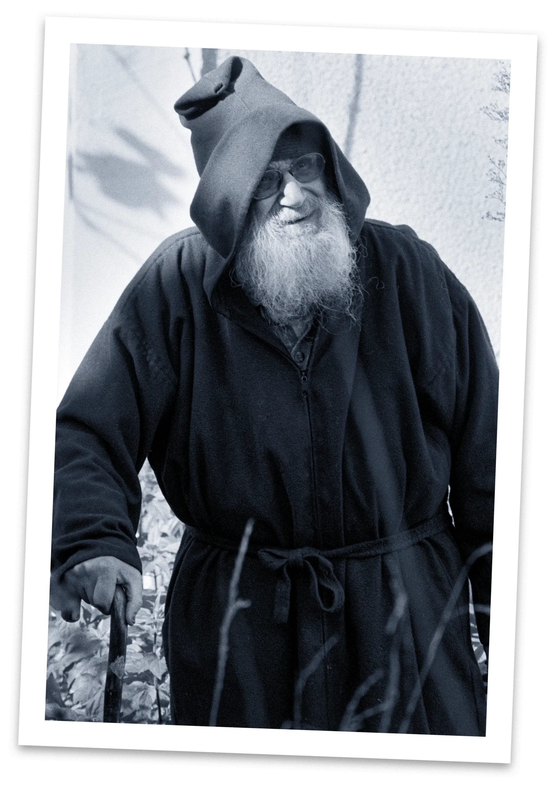 Bearded man wearing a hooded cloak.