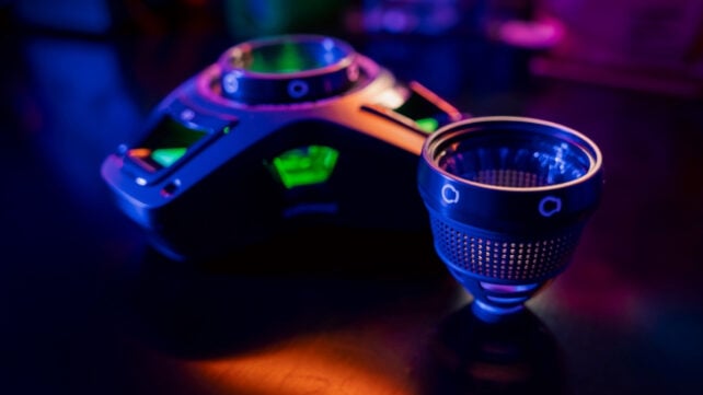 A 3D-printed artificial eggshell system is shown under colorful lab lighting.