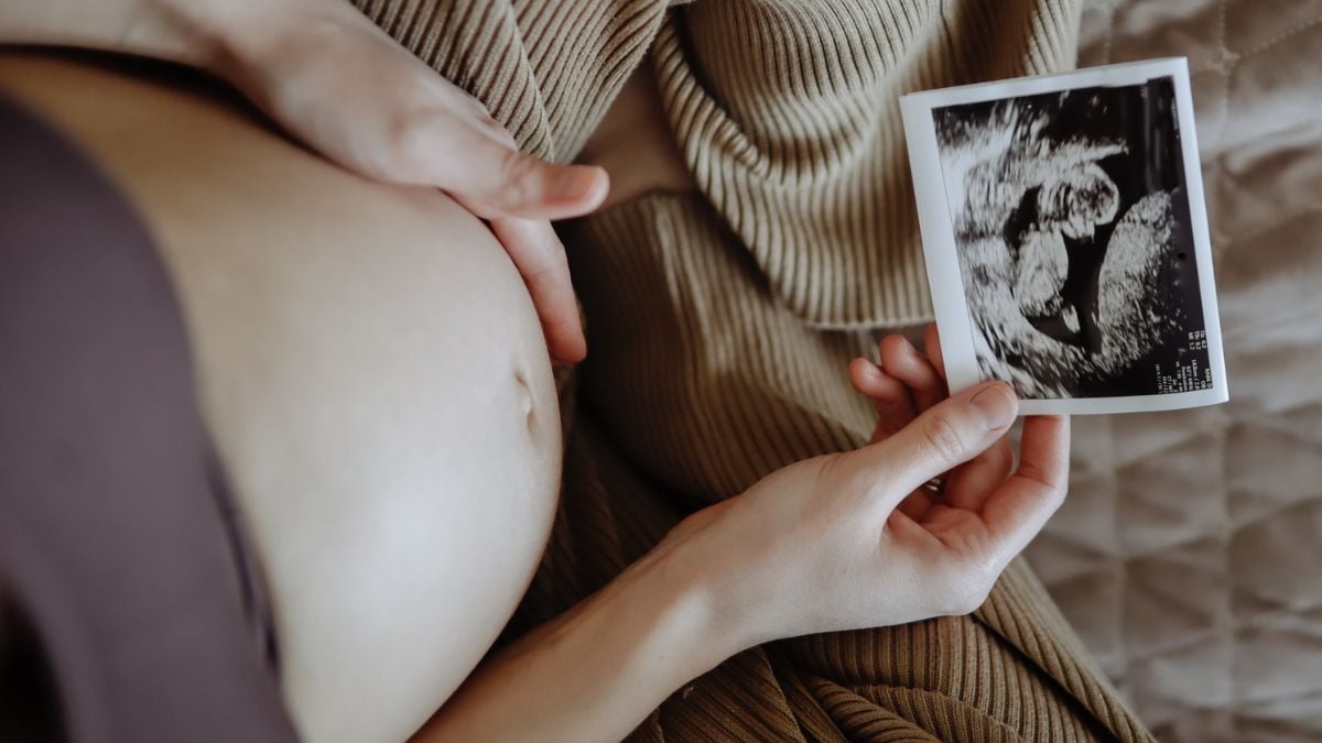 Pregnant belly with ultrasound scan image