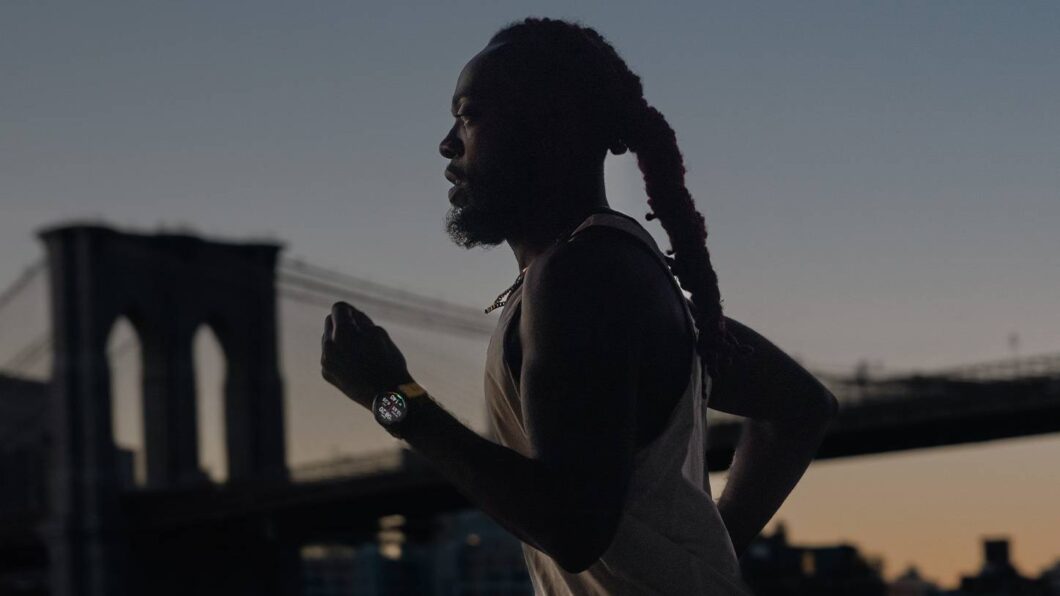 Homem correndo com o smartwatch Garmin Forerunner 965 no pulso durante treino ao ar livre, ao pôr do sol